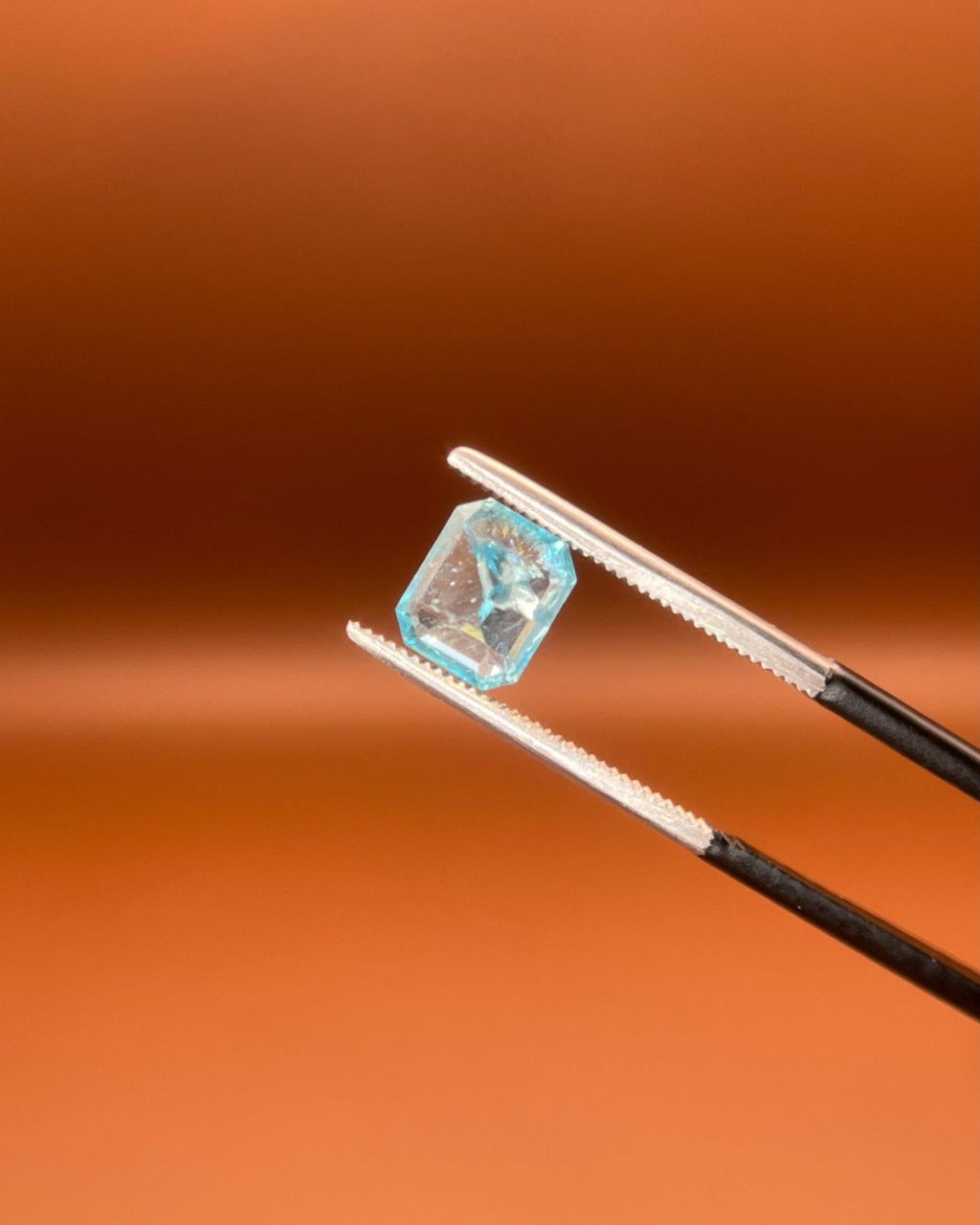 1.30ct Afghan indicolite tourmaline, pale blue emerald cut, step-cut facets
Natural light-blue indicolite tourmaline, 1.30ct emerald cut, held to the light
