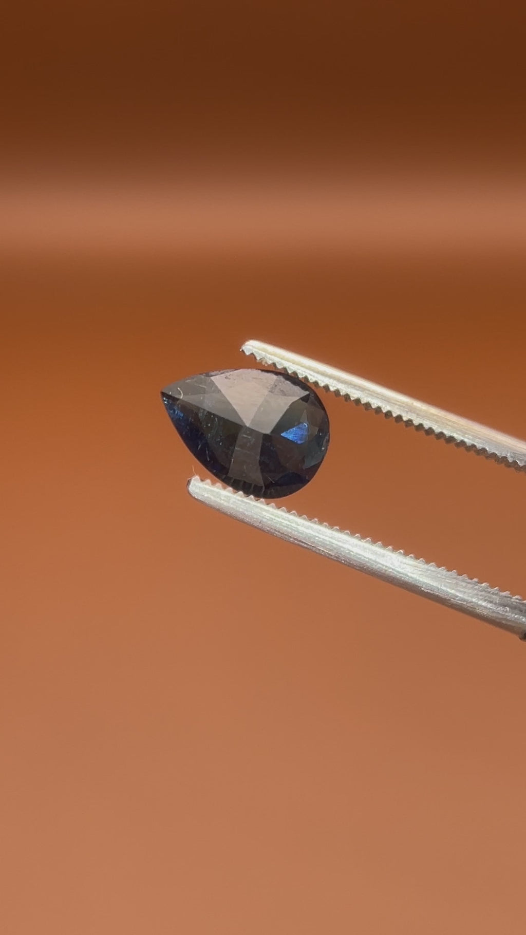 0.80ct Afghan indicolite tourmaline, inky blue-black pear cut, natural markings
Natural midnight-blue indicolite tourmaline, 0.80ct pear cut, held to the light